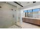 Sleek bathroom showcasing a glass-enclosed shower, double sink vanity, modern finishes, and a large mirror at 1548 Pleasant Bay Ct, Henderson, NV 89011