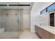 Bathroom featuring dual vanities, a glass-enclosed shower, and modern fixtures at 1548 Pleasant Bay Ct, Henderson, NV 89011