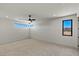Sunlit bedroom with neutral carpet and a modern ceiling fan, offering a comfortable and airy feel at 1548 Pleasant Bay Ct, Henderson, NV 89011