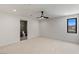 Bright bedroom featuring neutral carpet, a modern ceiling fan and a glimpse into the attached bathroom at 1548 Pleasant Bay Ct, Henderson, NV 89011