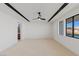 Bright bedroom features a modern ceiling fan, and large windows with views at 1548 Pleasant Bay Ct, Henderson, NV 89011