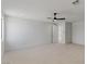 Spacious, carpeted bedroom featuring a modern ceiling fan and an open layout, flooded with natural light at 1548 Pleasant Bay Ct, Henderson, NV 89011