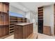 Spacious walk-in closet with custom shelving, drawers and a security safe at 1548 Pleasant Bay Ct, Henderson, NV 89011