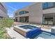 Modern home exterior with a private hot tub featuring blue tile accents and views of the home's design at 1548 Pleasant Bay Ct, Henderson, NV 89011