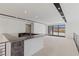 Modern kitchen featuring gray marble counters, sleek cabinetry, and bar seating at 1548 Pleasant Bay Ct, Henderson, NV 89011