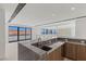 Modern kitchen featuring gray marble counters, sleek cabinetry, and bar seating at 1548 Pleasant Bay Ct, Henderson, NV 89011