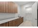 A neatly arranged laundry room provides plenty of storage space and a sink with counter at 1548 Pleasant Bay Ct, Henderson, NV 89011