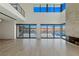 Spacious living room featuring a fireplace, multiple sliding glass doors offering scenic lake views at 1548 Pleasant Bay Ct, Henderson, NV 89011
