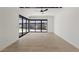 Bright living room featuring tiled flooring, modern sliding glass doors, and plenty of natural light at 1548 Pleasant Bay Ct, Henderson, NV 89011