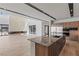 Bright, open-concept living space with large glass windows, a fireplace, and an attached kitchen area at 1548 Pleasant Bay Ct, Henderson, NV 89011