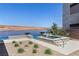 Lakeside pool and spa area with stunning water views and landscaping at 1548 Pleasant Bay Ct, Henderson, NV 89011