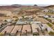 Expansive aerial view of a desert community with luxurious homes, landscaping, and mountain views at 16 Via Stefano, Henderson, NV 89011