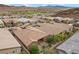 Aerial shot showcasing a desert neighborhood with lush gardens and desert flora at 16 Via Stefano, Henderson, NV 89011