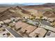 Desert community displaying luxurious homes with desert landscaping, mountain views and a winding street at 16 Via Stefano, Henderson, NV 89011