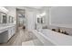 Bright bathroom featuring a soaking tub, double vanity, and neutral tones at 16 Via Stefano, Henderson, NV 89011