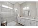 Bathroom featuring glass enclosed shower, a spacious vanity with dual sinks at 16 Via Stefano, Henderson, NV 89011