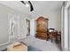 Bedroom featuring large armoire, desk, and doorway to the bathroom at 16 Via Stefano, Henderson, NV 89011