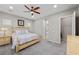 Bedroom with a large king bed, ceiling fan, carpet floors, and two bright windows at 16 Via Stefano, Henderson, NV 89011