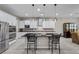Bright kitchen with a large island, stainless steel appliances, and stylish pendant lighting at 16 Via Stefano, Henderson, NV 89011