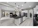 Modern kitchen with granite island that opens to the living area at 16 Via Stefano, Henderson, NV 89011