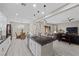 Open concept kitchen with stainless steel appliances, dark counters, and view of living area at 16 Via Stefano, Henderson, NV 89011