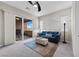 Cozy living room with an inviting blue sofa and sliding door access to the patio at 16 Via Stefano, Henderson, NV 89011