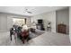 Bright living room with tile floors, modern ceiling fan, and access to the patio at 16 Via Stefano, Henderson, NV 89011