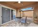 Cozy covered patio with ceiling fan, table and chairs, perfect for outdoor dining at 16 Via Stefano, Henderson, NV 89011