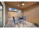 Inviting covered patio featuring a ceiling fan and a stylish outdoor dining set at 16 Via Stefano, Henderson, NV 89011