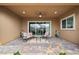 Charming patio with comfortable seating overlooking a landscaped backyard and blue skies at 16 Via Stefano, Henderson, NV 89011