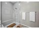 Modern shower with glass doors, bench, and neutral tones at 16 Via Stefano, Henderson, NV 89011