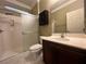Bathroom featuring a sliding glass shower, vanity, dark wood cabinets and tile floors at 2112 Merganser Ct, North Las Vegas, NV 89084