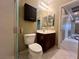 Bathroom featuring a white toilet, sink with dark wood cabinets, and tile floors at 2112 Merganser Ct, North Las Vegas, NV 89084