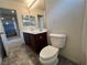Bright bathroom featuring a vanity with dual sinks and white toilet at 2112 Merganser Ct, North Las Vegas, NV 89084