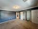 A carpeted bedroom featuring a closet with white doors and crown molding at 2112 Merganser Ct, North Las Vegas, NV 89084