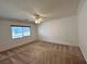 Bedroom featuring a ceiling fan, carpet, and window with blinds at 2112 Merganser Ct, North Las Vegas, NV 89084