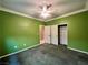 Green bedroom featuring a closet with white doors, carpet, and a ceiling fan at 2112 Merganser Ct, North Las Vegas, NV 89084