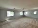 Large upstairs bonus room with multiple windows and plush carpeting at 2112 Merganser Ct, North Las Vegas, NV 89084