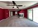 Bonus room with neutral carpet, fireplace, ceiling fan, and sliding glass door at 2112 Merganser Ct, North Las Vegas, NV 89084