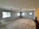 Spacious bonus room with carpeted floors, neutral paint, and natural light from multiple windows at 2112 Merganser Ct, North Las Vegas, NV 89084