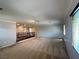 An open bonus room with neutral carpeting, a wooden banister, and ample natural light at 2112 Merganser Ct, North Las Vegas, NV 89084