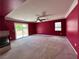 Large bonus room with fireplace, carpet floors, and sliding glass door access to outdoor space at 2112 Merganser Ct, North Las Vegas, NV 89084