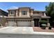 Two-story home boasts a three-car garage and desert landscaping at 2112 Merganser Ct, North Las Vegas, NV 89084