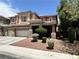 Two-story home features mature trees, desert landscaping, and three-car garage at 2112 Merganser Ct, North Las Vegas, NV 89084