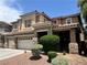 Charming two-story home with desert landscaping and a three-car garage at 2112 Merganser Ct, North Las Vegas, NV 89084