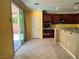Open kitchen area with stainless appliances, tiled floors, and slider door access to the backyard at 2112 Merganser Ct, North Las Vegas, NV 89084