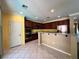 Bright eat-in kitchen with tile flooring, stainless appliances, and ample countertop space at 2112 Merganser Ct, North Las Vegas, NV 89084