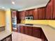 Well-equipped kitchen featuring rich wood cabinetry, modern appliances, and a tiled floor at 2112 Merganser Ct, North Las Vegas, NV 89084