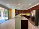 Spacious kitchen with stainless steel appliances, center island, and sliding door access to backyard at 2112 Merganser Ct, North Las Vegas, NV 89084