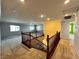 Second floor landing with wooden railing, plush carpet, and abundant natural light at 2112 Merganser Ct, North Las Vegas, NV 89084